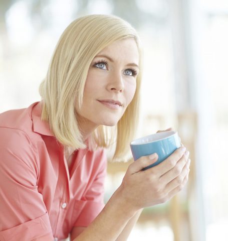 Woman holding cup of coffee