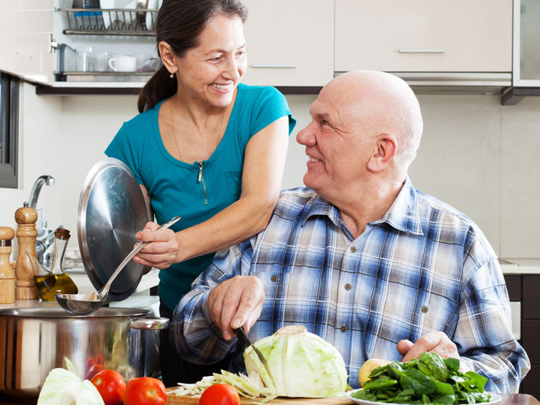 A caregiver provides housekeeping for seniors for an elderly male client in Syracuse.