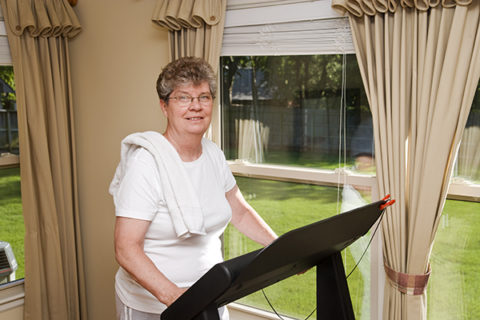 An older woman receiving elderly care in Syracuse participates in treadmill therapy.