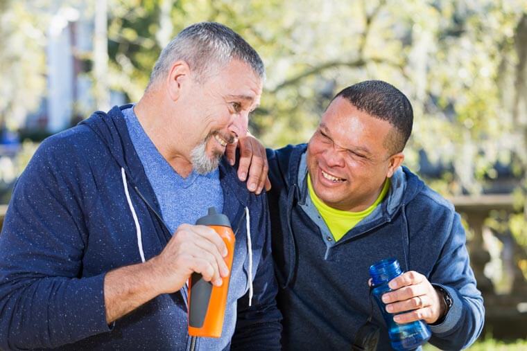 Caregiver and client being active outdoors with the help of independent living assistance in Syracuse.