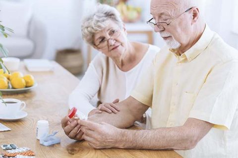 elderly husband and wife contemplating medications and supplements