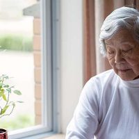 lonely-senior-woman-by-window