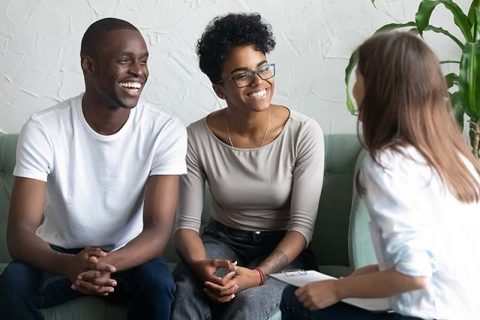 happy couple talking with caregiver