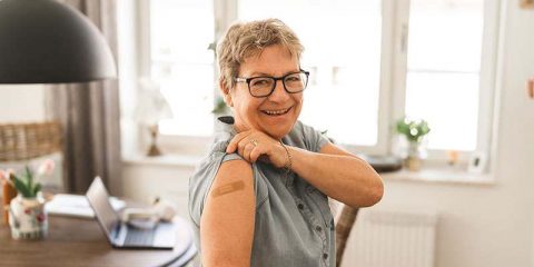 senior-woman-showing-bandage-on-arm