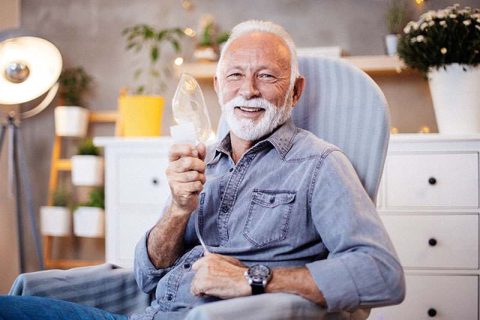 happy-senior-man-holding-oxygen-mask