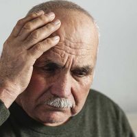 senior man holding head