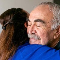 _caregiver-hugging-senior-man