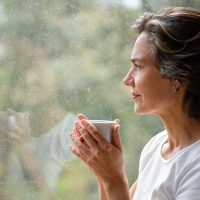 female caregiver looking out window