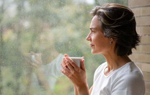 female caregiver looking out window