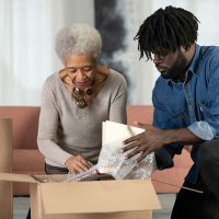 senior lady and son packing box