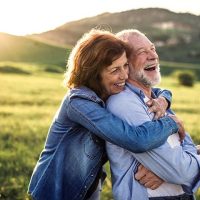 happy hugging seniors