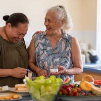 happy ladies fixing food