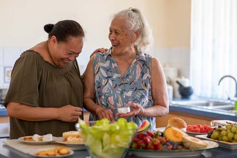 happy ladies fixing food