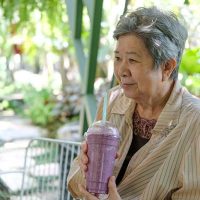 happy-senior-lady-drinking-smoothie