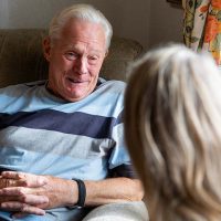 caregiver talking with senior man with dementia