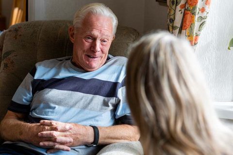 caregiver talking with senior man with dementia