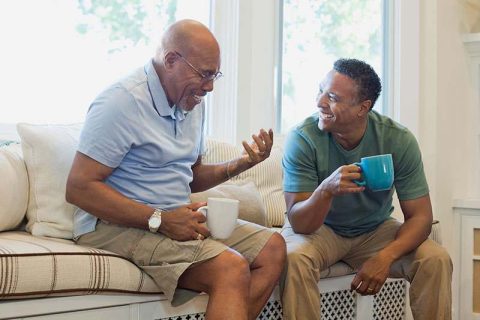 The adult child of a senior with dementia responds to conversation loops as they talk over coffee.