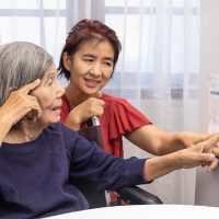 dementia-lady-with-caregiver-pointing-to-calendar