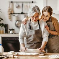 The adult child of a senior practices dementia care cooking tips for seniors.